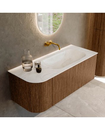 Mondiaz Kurve-Dlux 115cm badmeubel ronding Links kleur Walnut met 1 lade en 1 deur. Wastafel Big small Rechts zonder kraangat Ostra.